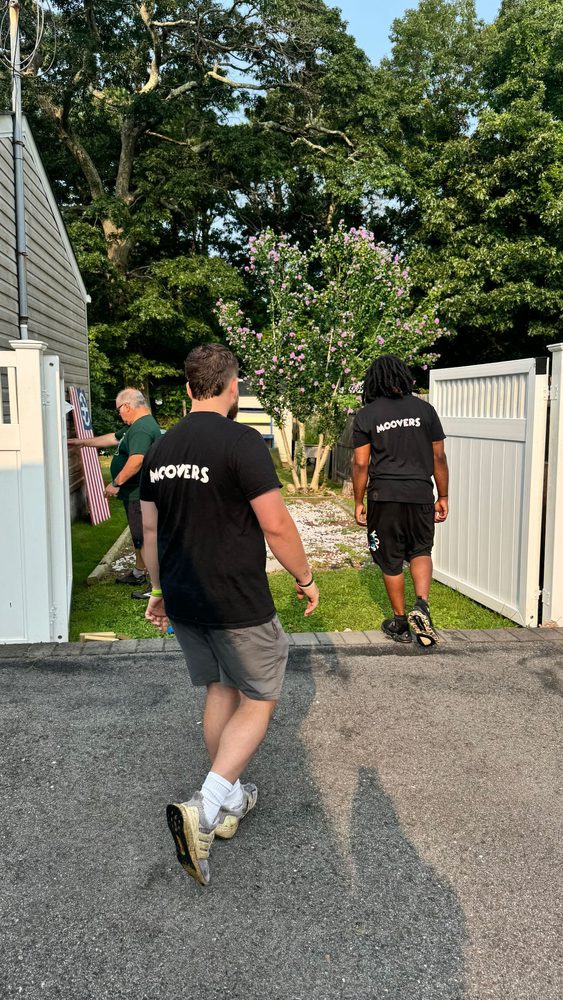 Moovers crew wrapping and loading furniture on the job